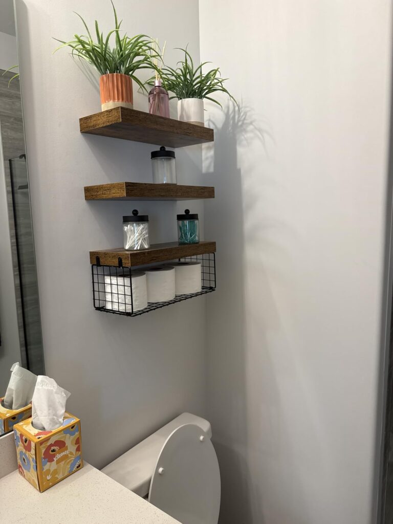 over toilet bathroom shelves mounted above toilet with towels and toiletries
